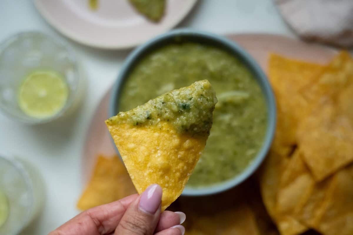 Salsa Verde dipped in a tortilla chip.