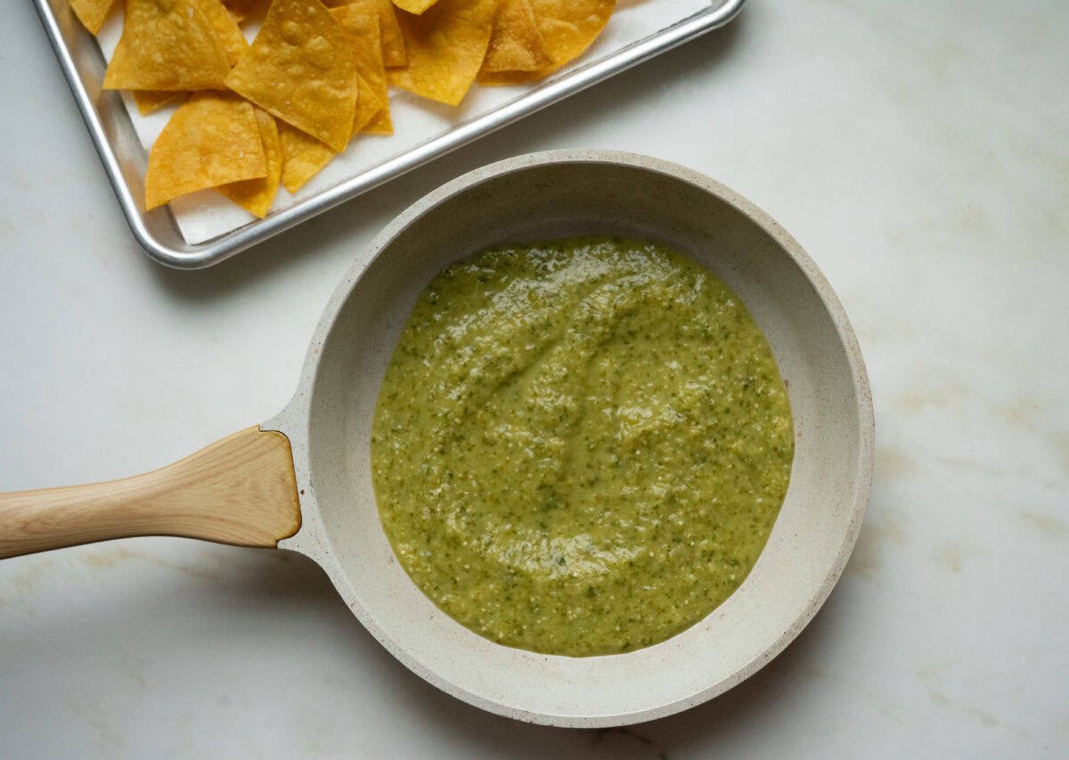 Salsa Verde in a pot is heated.