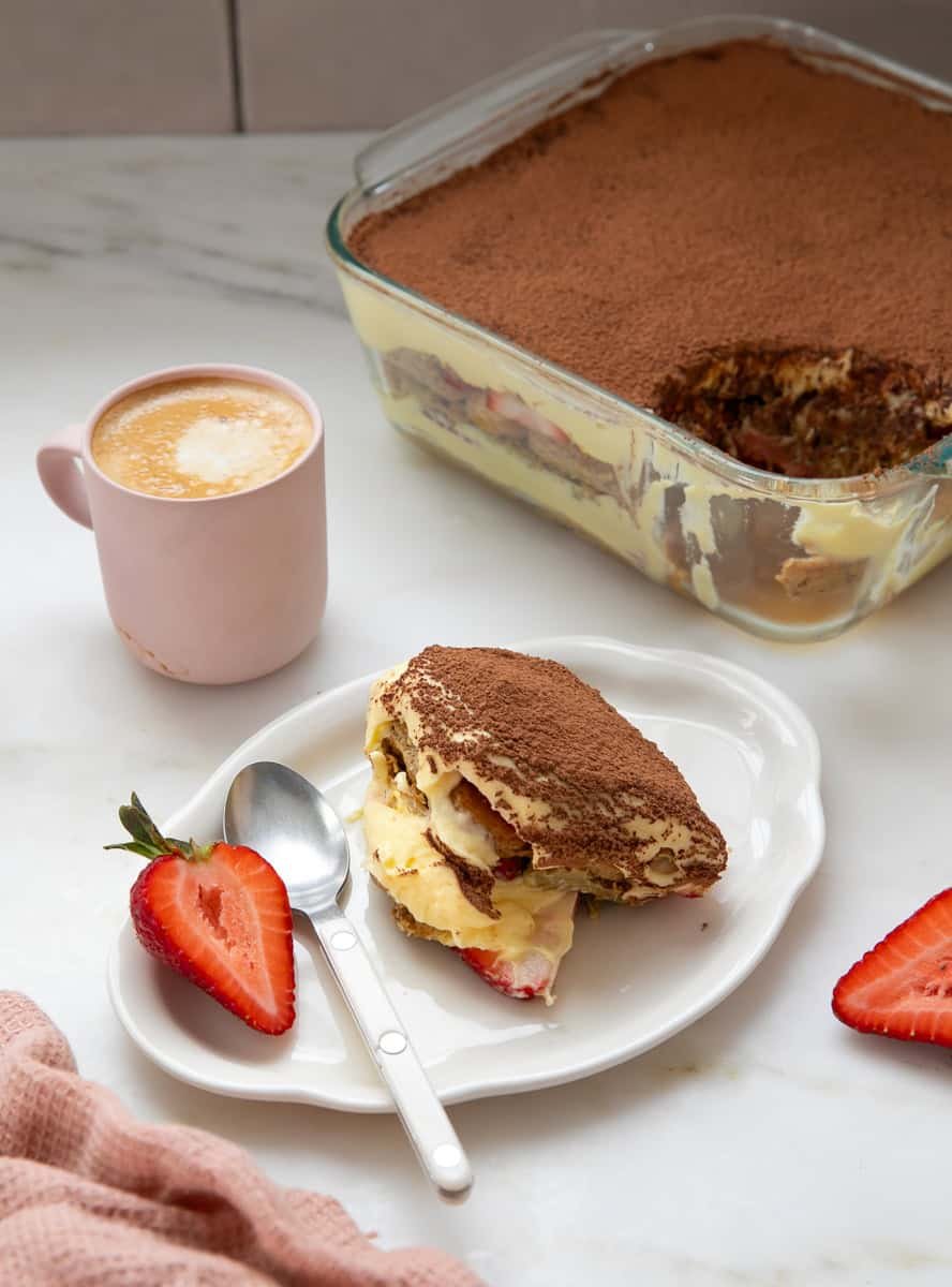 Dubai Chocolate Tiramisu on a plate with main course at the back.