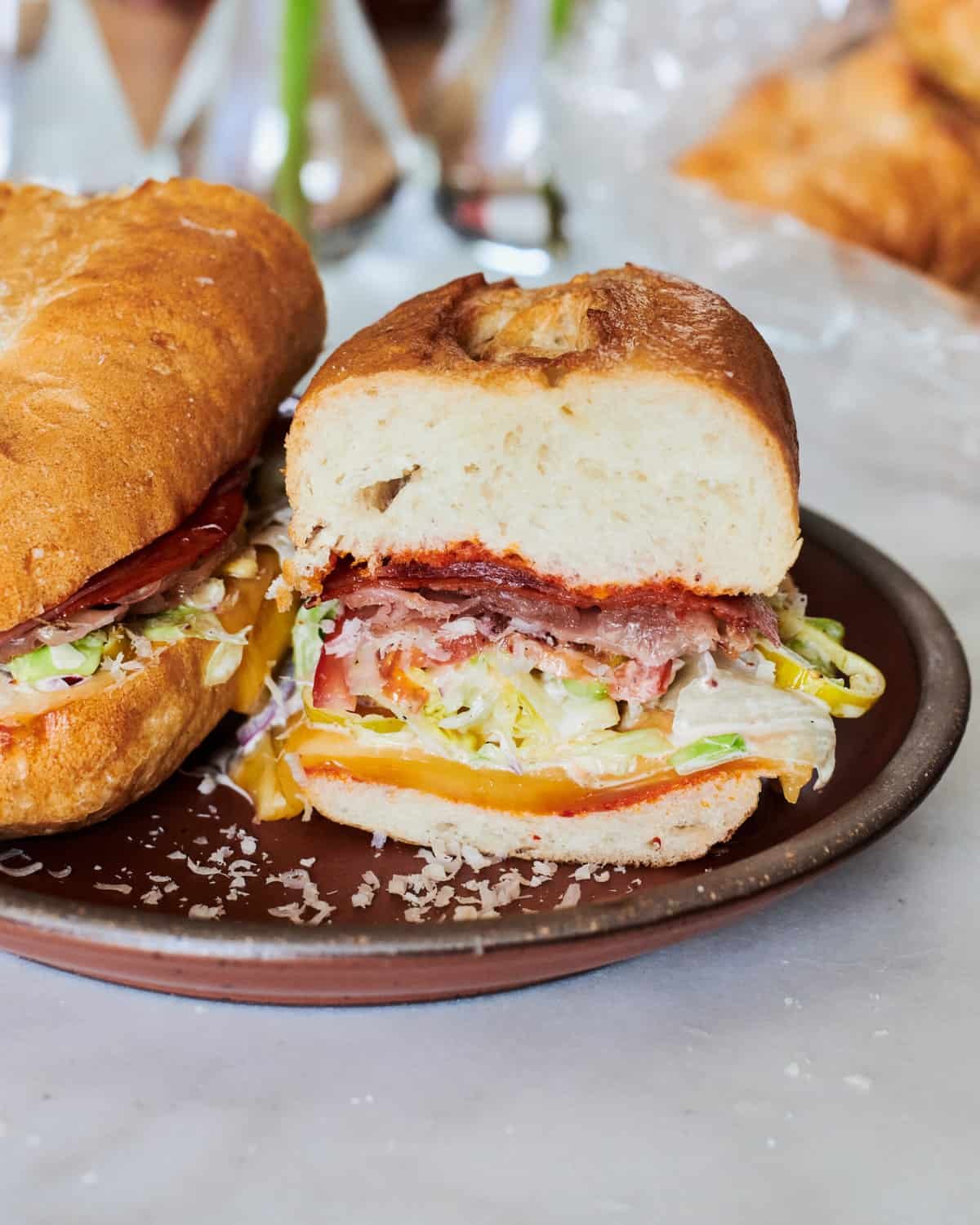 Grinding sandwiches on a plate. With salami, prosciutto sand salad, cheese and more. All on a plate.