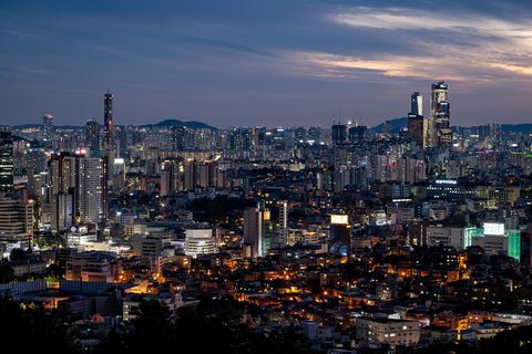 Wide view of the city's lights lit in the early evening